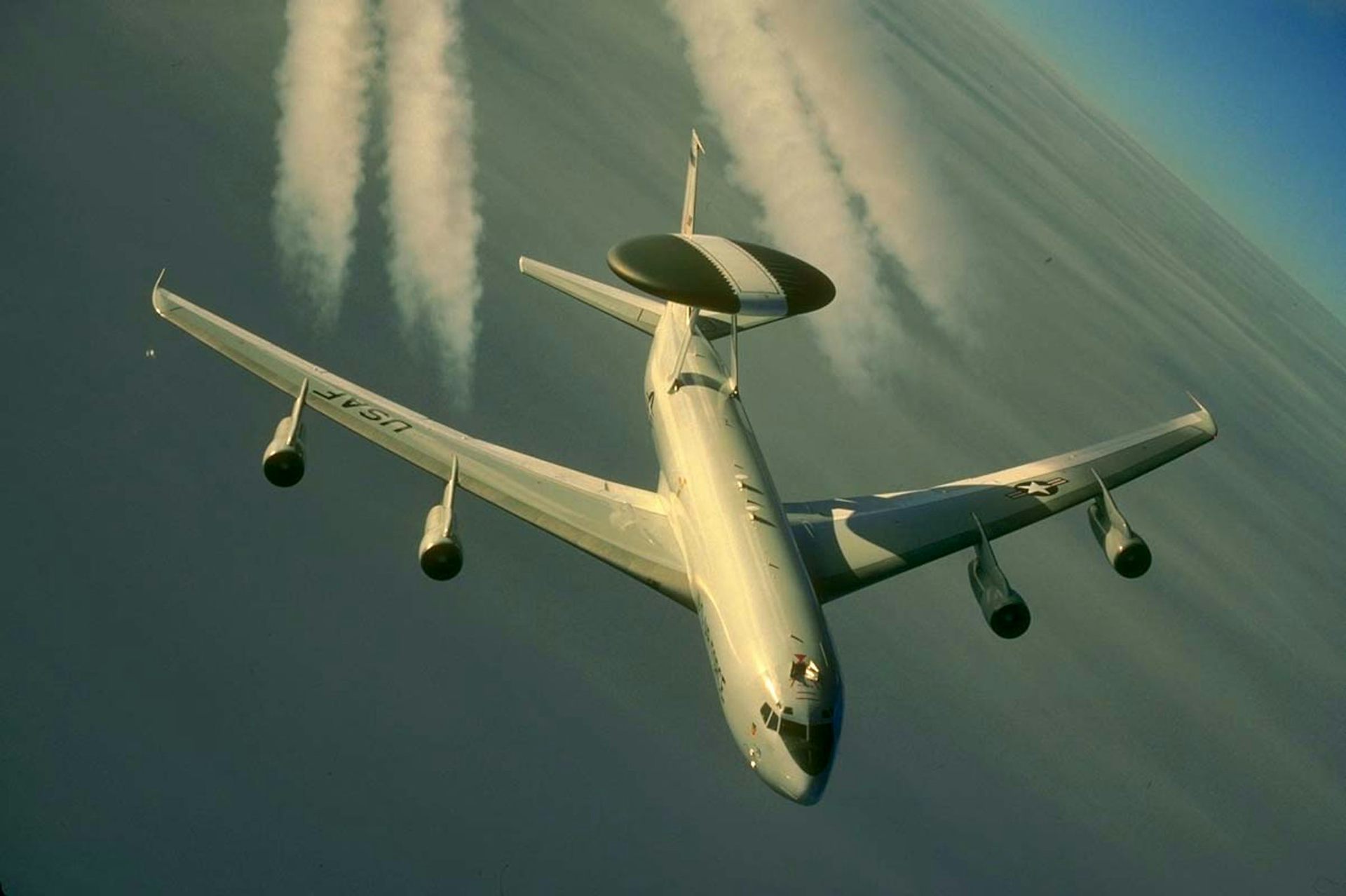 a four-engine jet aircraft with a large disk mounted on the rear of the fuselage in flight