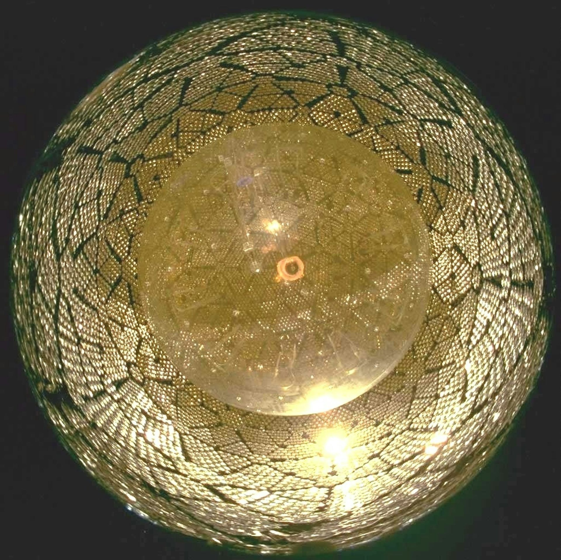 A spherical chamber lined with detector equipment.